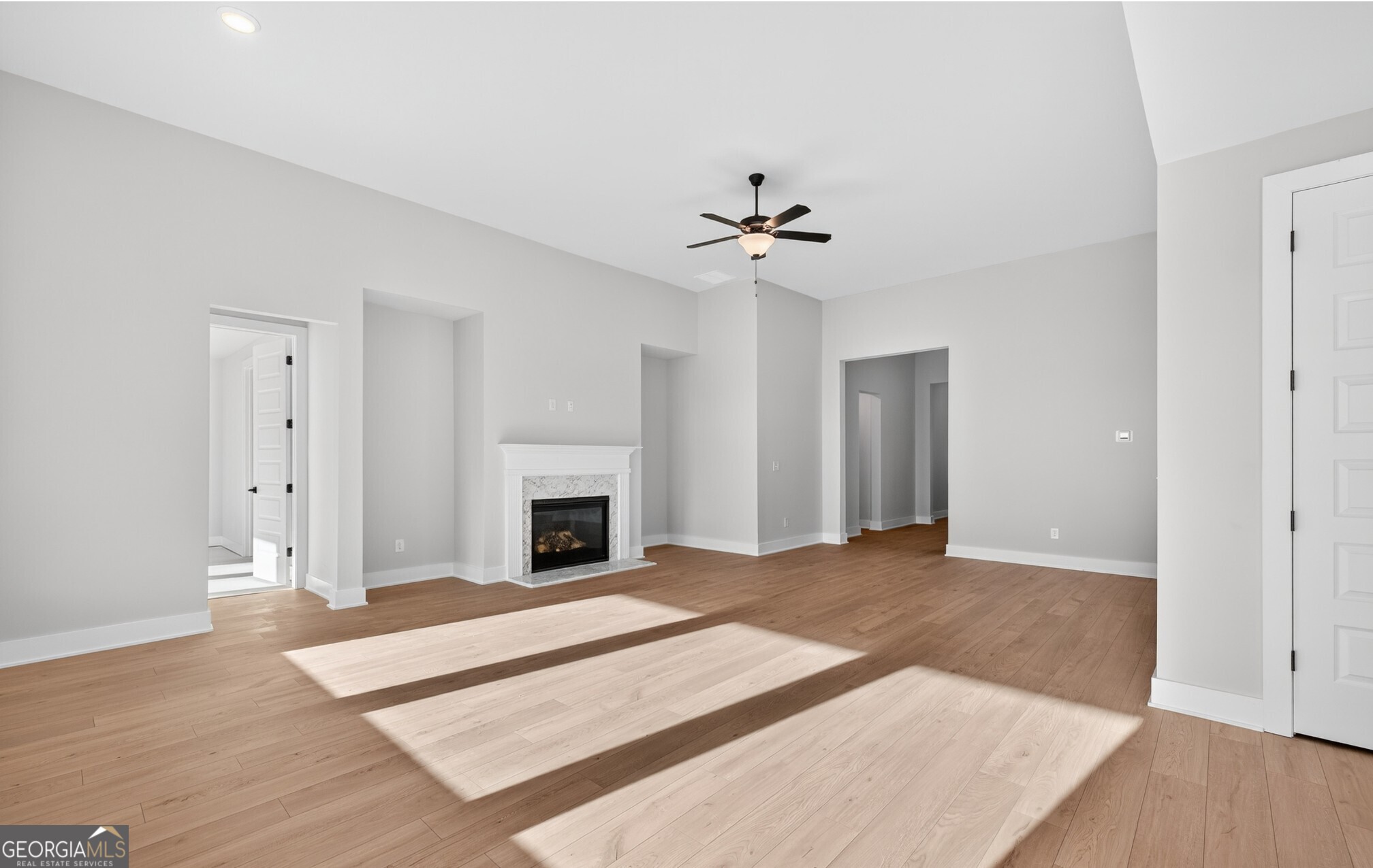 132 Patillo Manor, Unit 8 Stockbridge, GA 30281 - Photo 16 of 36 a view of an empty room with chandelier fan and fire place