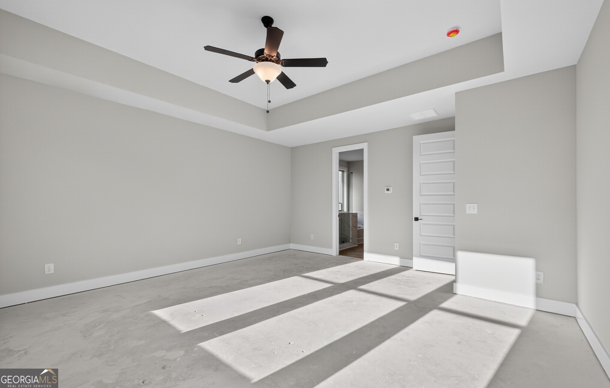 132 Patillo Manor, Unit 8 Stockbridge, GA 30281 - Photo 25 of 36 a bedroom with a large bed and a chandelier