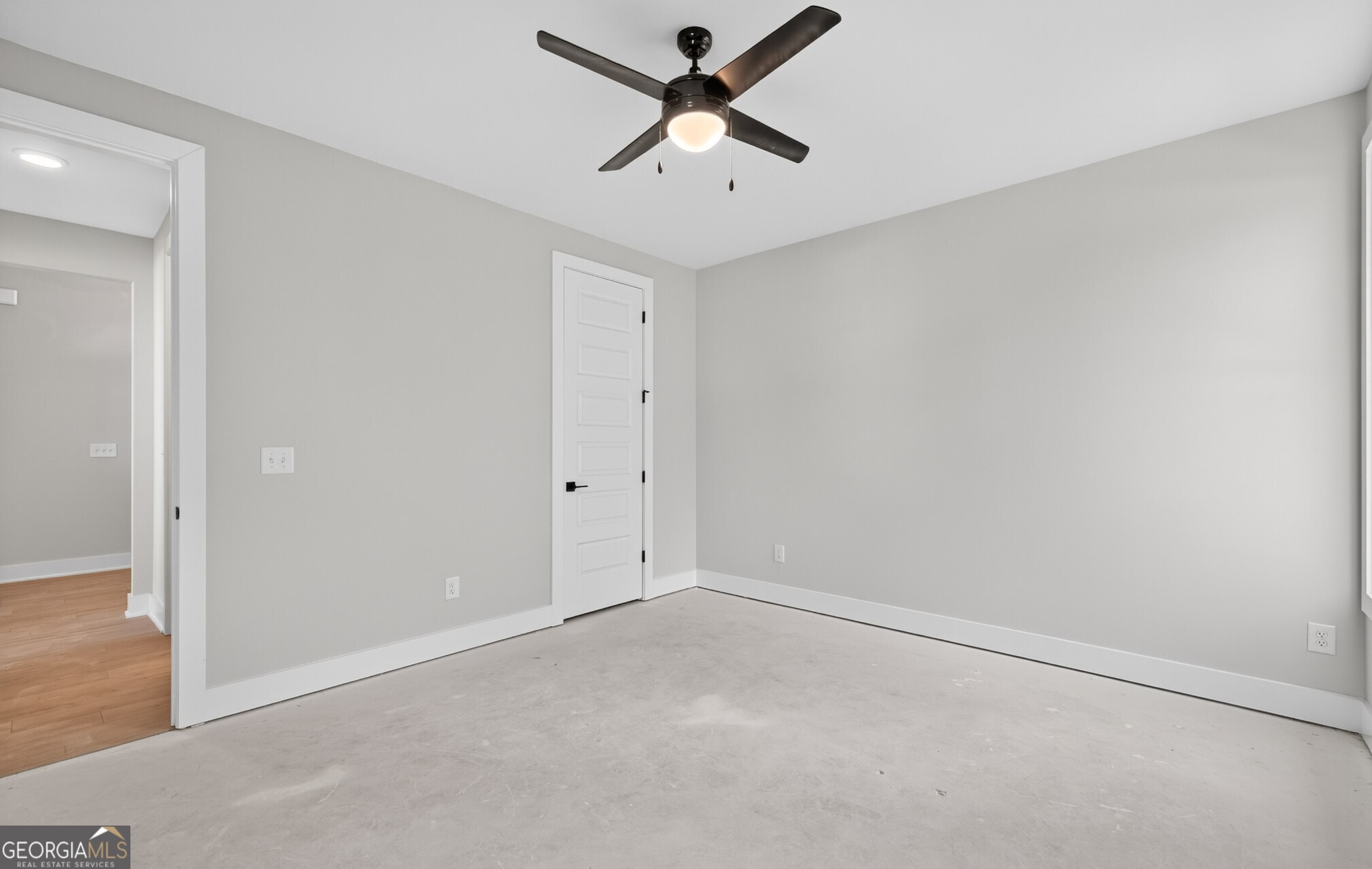 132 Patillo Manor, Unit 8 Stockbridge, GA 30281 - Photo 35 of 36 an empty room with a ceiling fan and a window