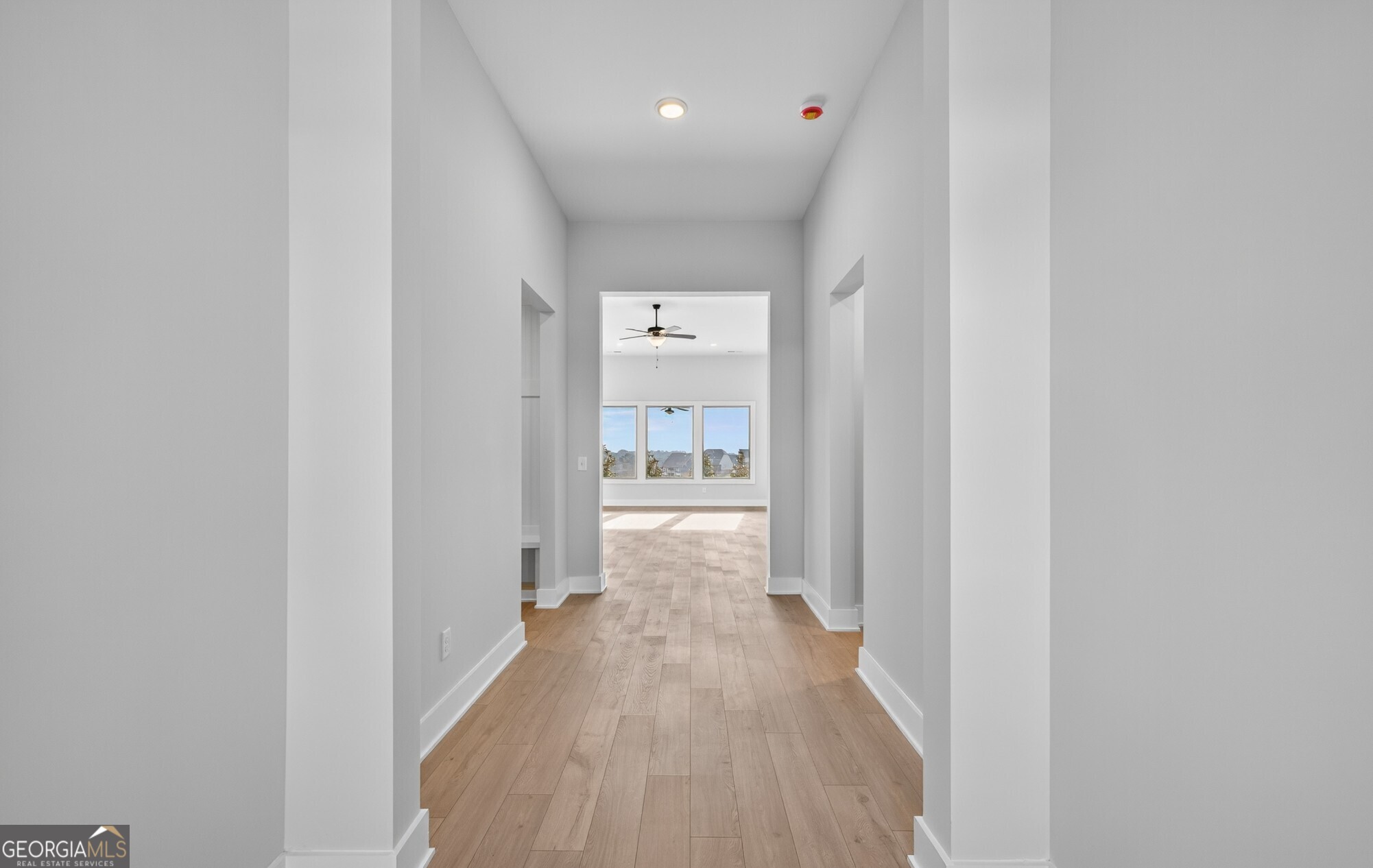 132 Patillo Manor, Unit 8 Stockbridge, GA 30281 - Photo 8 of 36 a view of a hallway with wooden floor and a bathroom