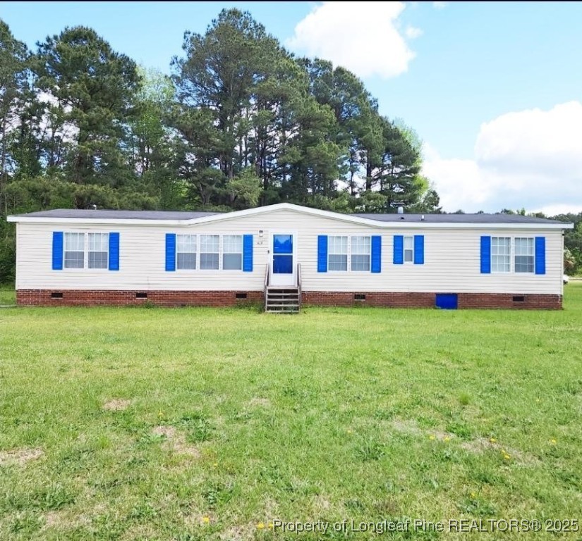 420 Pine Tree Road Lumberton, NC 28360 - Photo 1 of 18 a view of a house with a backyard and a patio