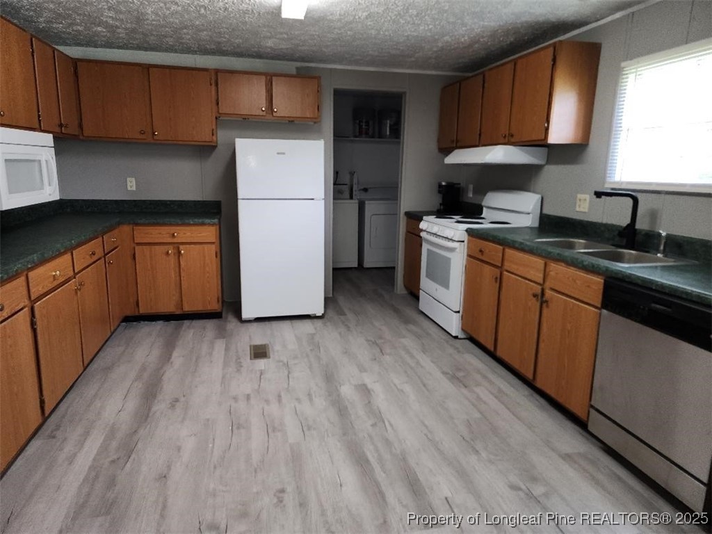 420 Pine Tree Road Lumberton, NC 28360 - Photo 17 of 18 a kitchen with a refrigerator wooden floor and a sink