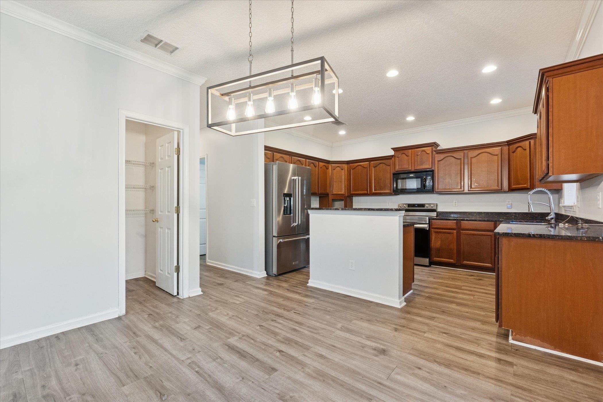 140 Corral Circle St. Augustine, FL 32092 - Photo 11 of 46 a kitchen with stainless steel appliances granite countertop a refrigerator a stove and a wooden floors