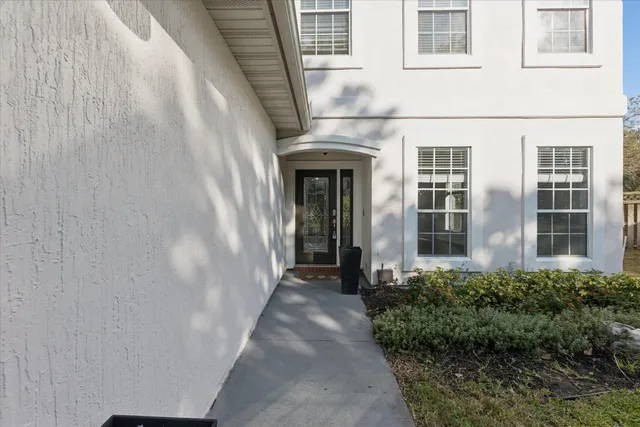 a view of a brick house with a large window