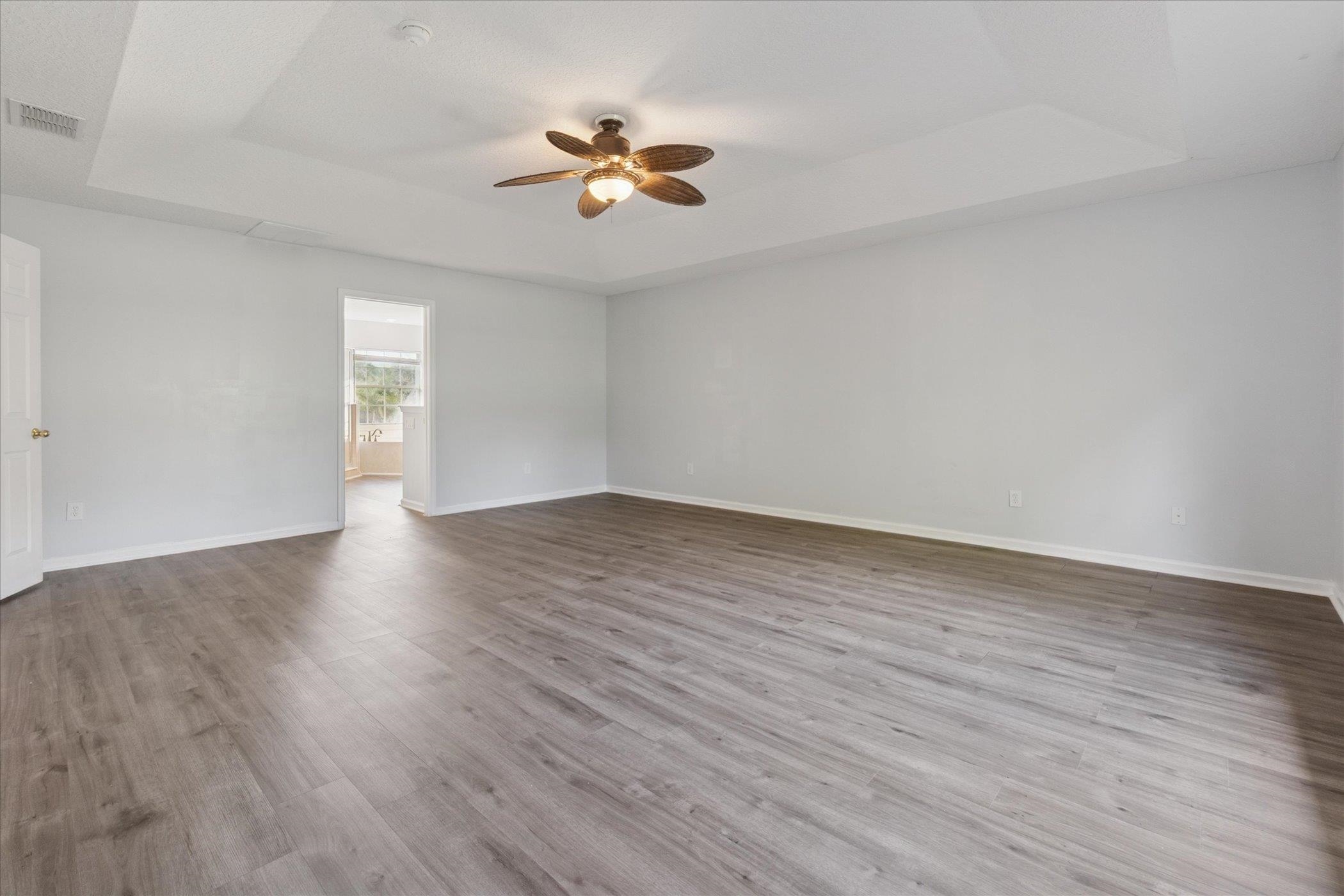 140 Corral Circle St. Augustine, FL 32092 - Photo 21 of 46 a view of an empty room with wooden floor and window