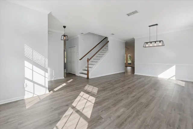 a view of entryway and hall with wooden floor