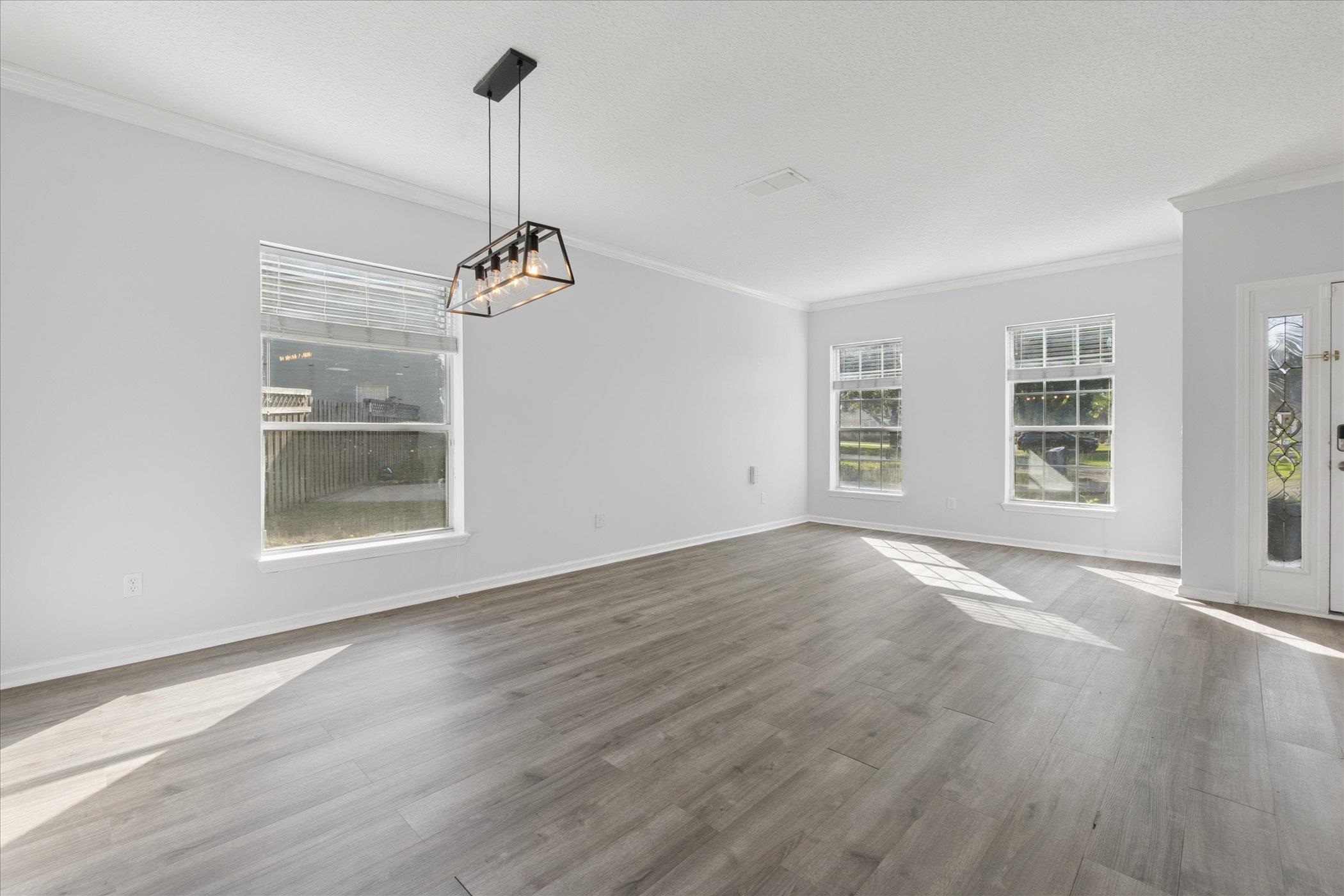 140 Corral Circle St. Augustine, FL 32092 - Photo 26 of 46 a view of an empty room with a window and wooden floor