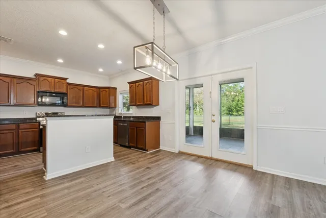 a kitchen with stainless steel appliances a refrigerator sink and cabinets