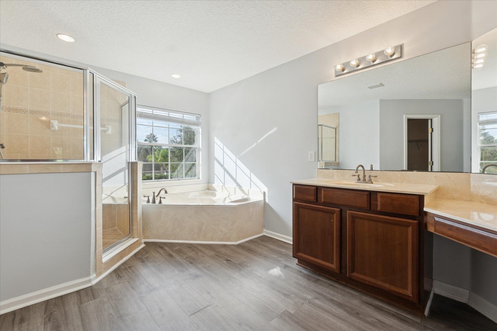 140 Corral Circle St. Augustine, FL 32092 - Photo 30 of 46 a bathroom with a sink vanity granite tub and a mirror