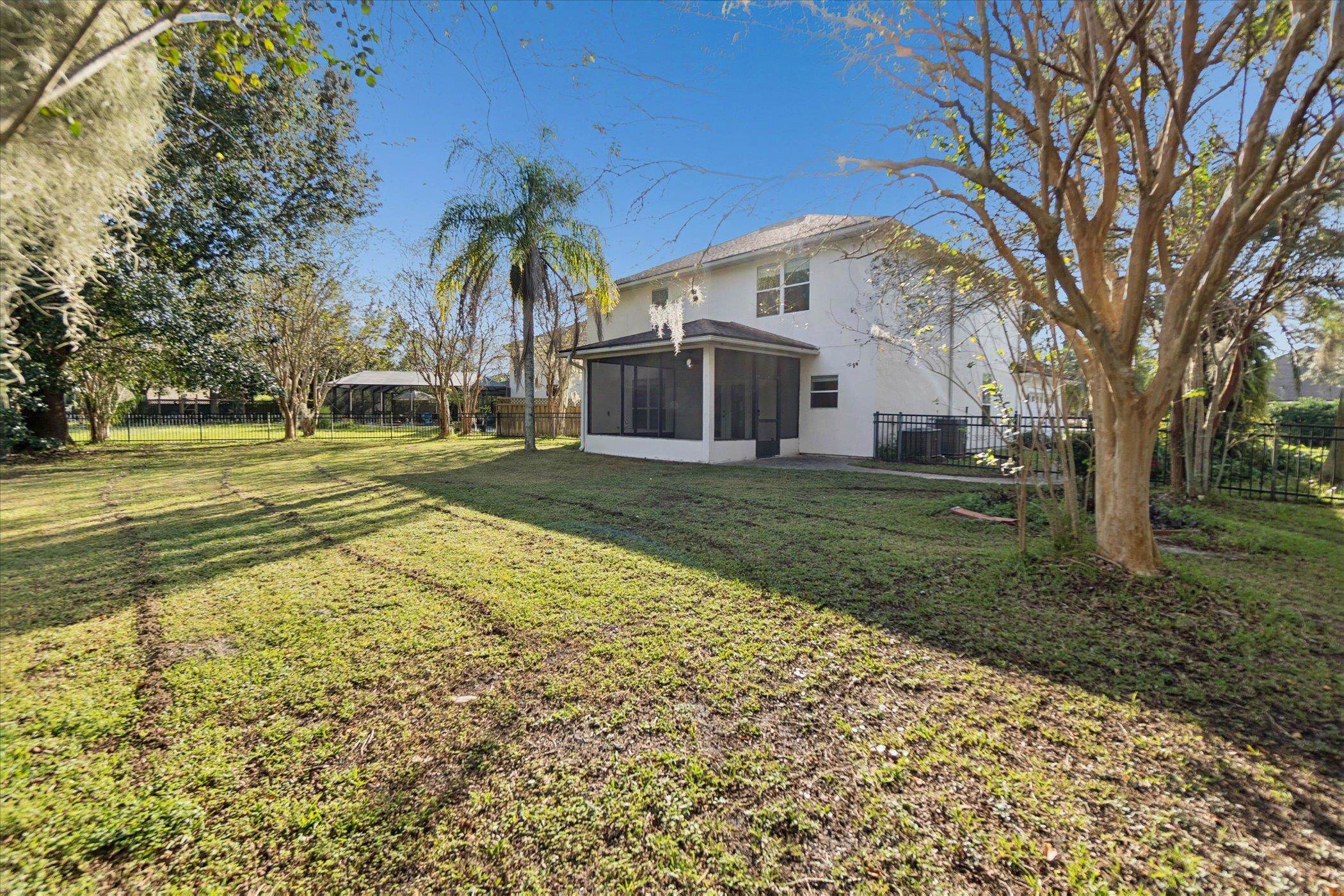 140 Corral Circle St. Augustine, FL 32092 - Photo 39 of 46 a view of a house with a yard and palm trees