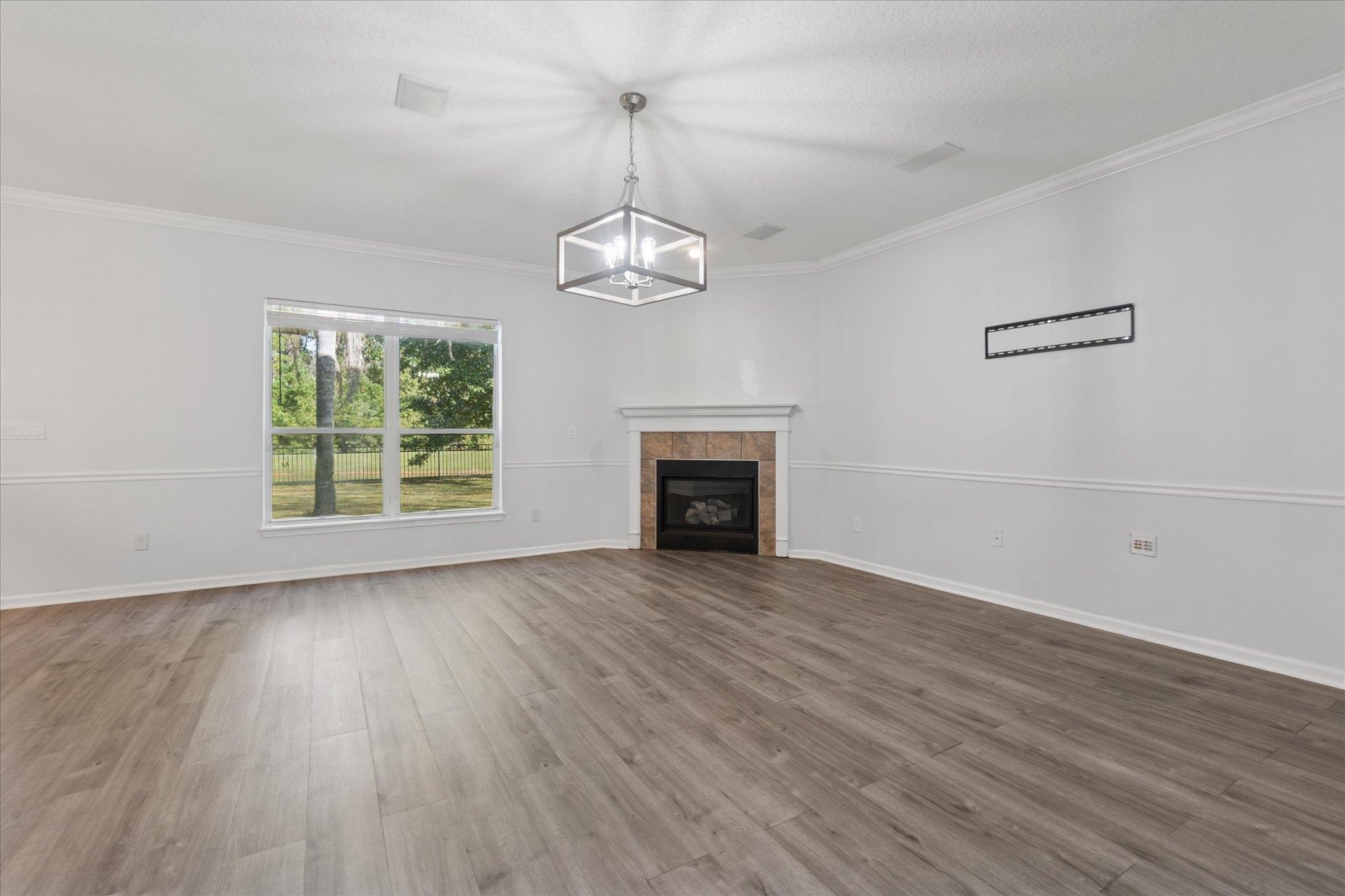 140 Corral Circle St. Augustine, FL 32092 - Photo 40 of 46 an empty room with wooden floor fireplace and windows