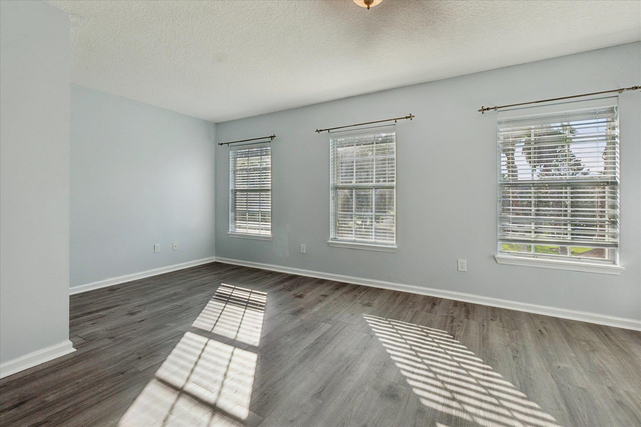 140 Corral Circle St. Augustine, FL 32092 - Photo 44 of 46 an empty room with wooden floor and windows