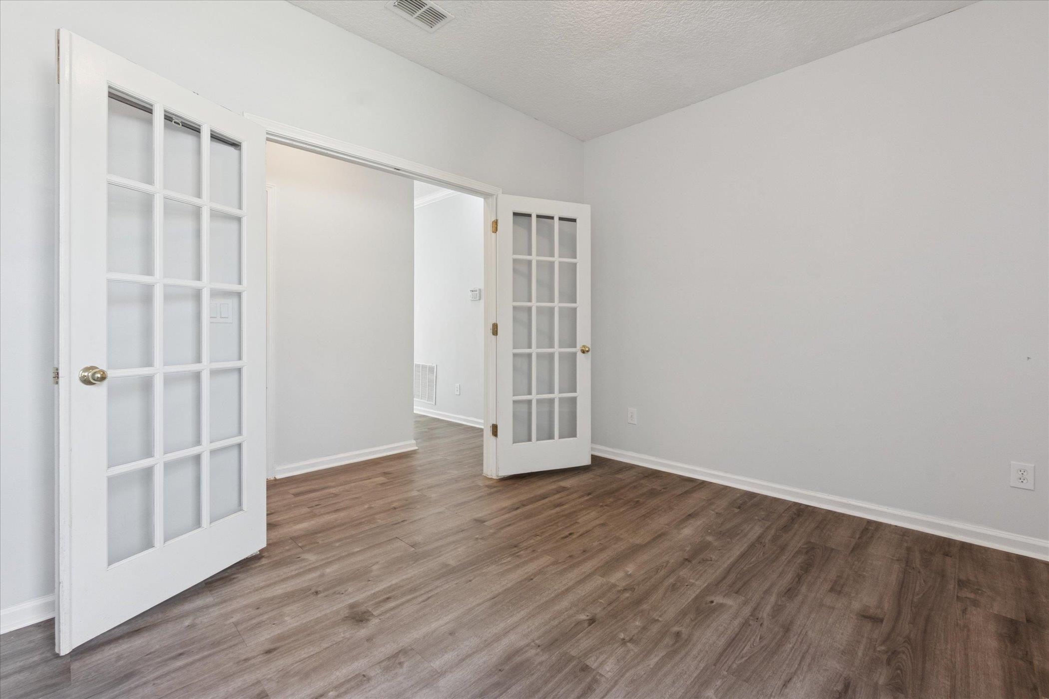 140 Corral Circle St. Augustine, FL 32092 - Photo 5 of 46 an empty room with wooden floor and windows