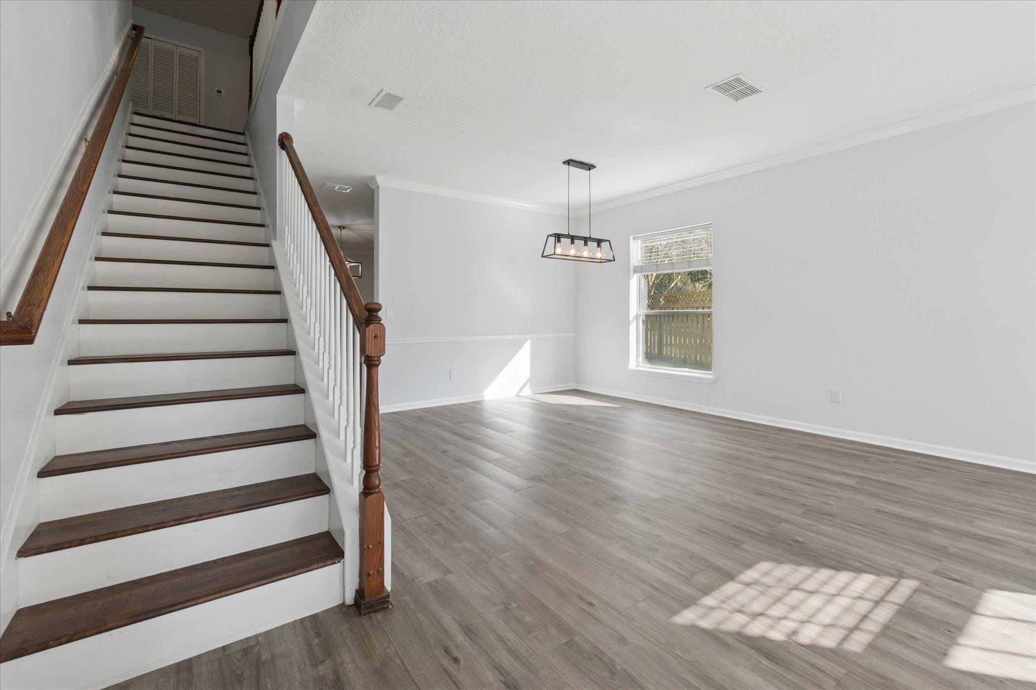 140 Corral Circle St. Augustine, FL 32092 - Photo 7 of 46 wooden floor in an empty room with a window