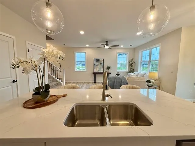 a kitchen with a sink and living room