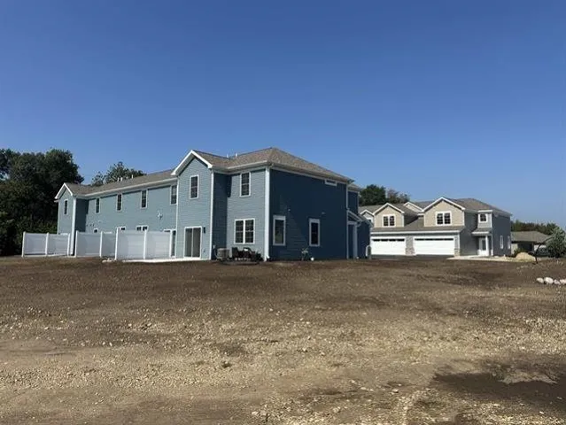 a front view of a house with a garden and garage