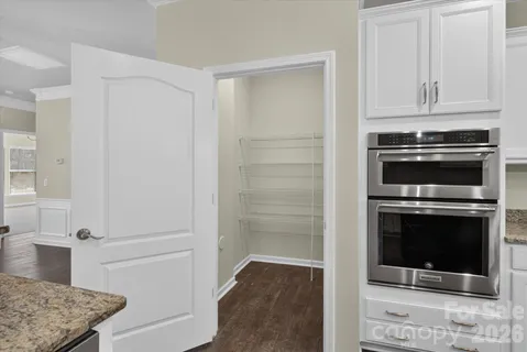 a kitchen with kitchen island granite countertop wooden cabinets and a granite counter tops