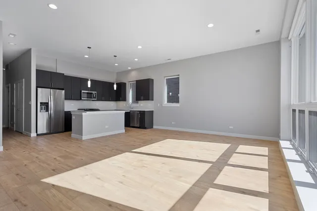 a view of kitchen with stainless steel appliances kitchen island a refrigerator sink a stove and oven