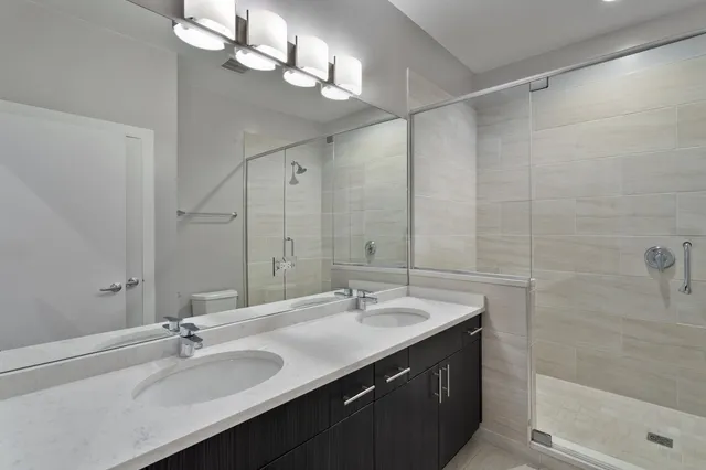 a bathroom with a sink double vanity and a mirror