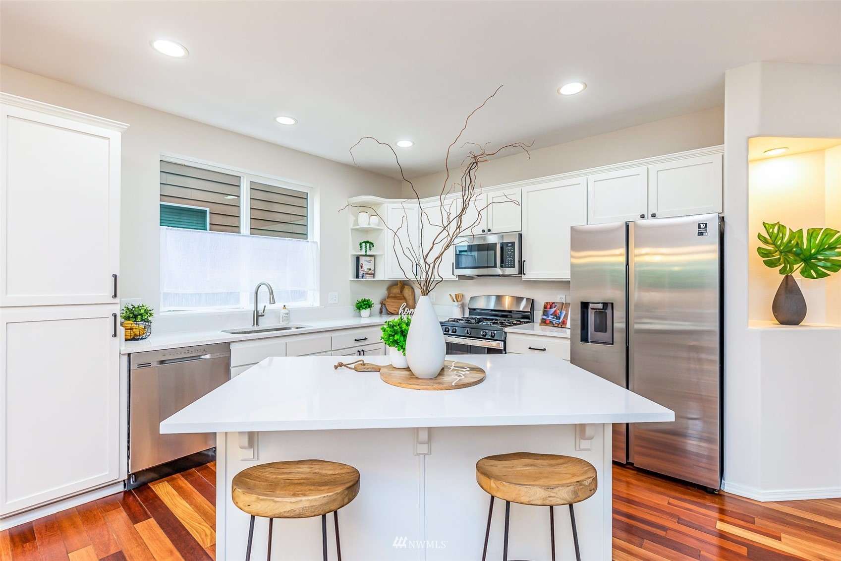 3331 182nd Place Southeast Bothell, WA 98012 - Photo 8 of 29 a kitchen with refrigerator and chairs