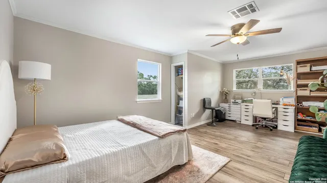 a bedroom with a large bed and a chandelier
