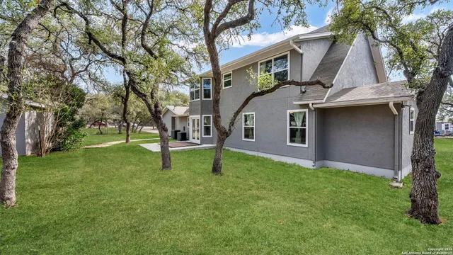 a view of house with a yard