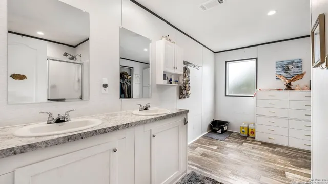 a bathroom with a sink double vanity and a mirror
