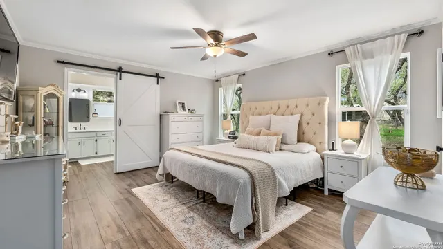 a spacious bedroom with a bed and a large window