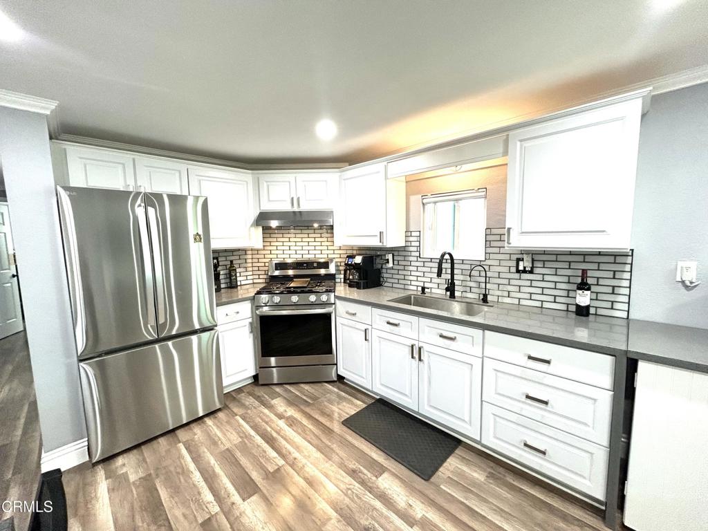 250 East Telegraph Road, Unit 184 Fillmore, CA 93015 - Photo 3 of 16 a kitchen with granite countertop a refrigerator stove and sink