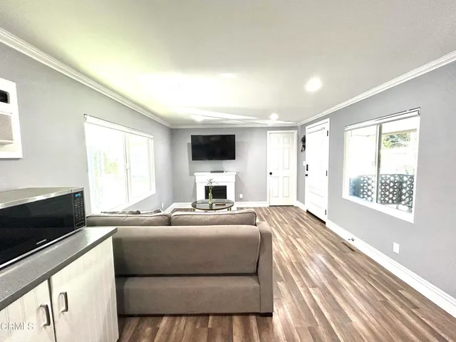 a bedroom with a balcony a bed and a flat screen tv