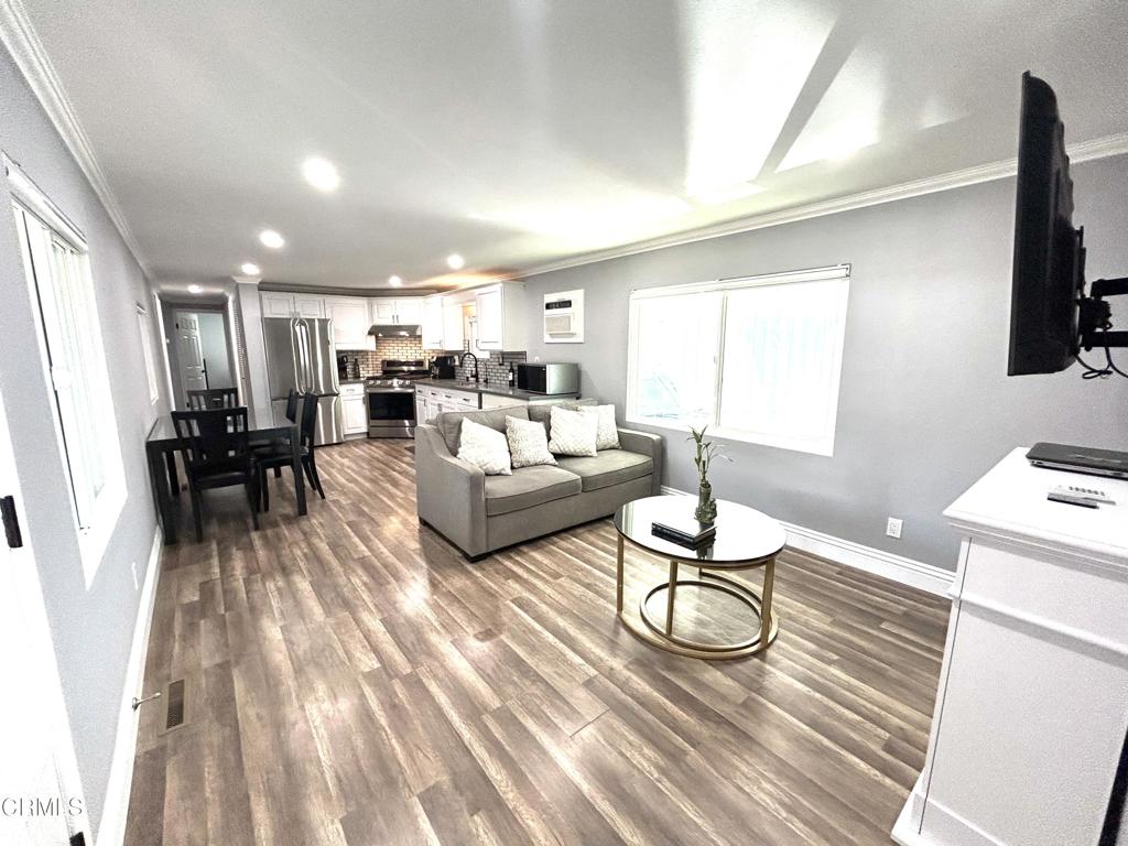 250 East Telegraph Road, Unit 184 Fillmore, CA 93015 - Photo 6 of 16 a living room with furniture a flat screen tv and a table