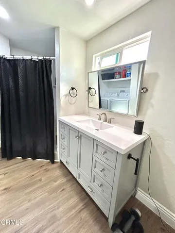 a bathroom with a sink vanity and mirror