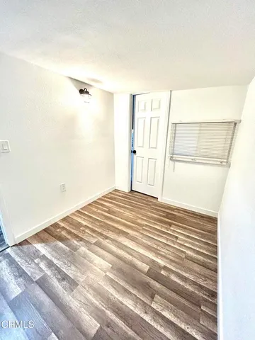 a view of a room with wooden floor