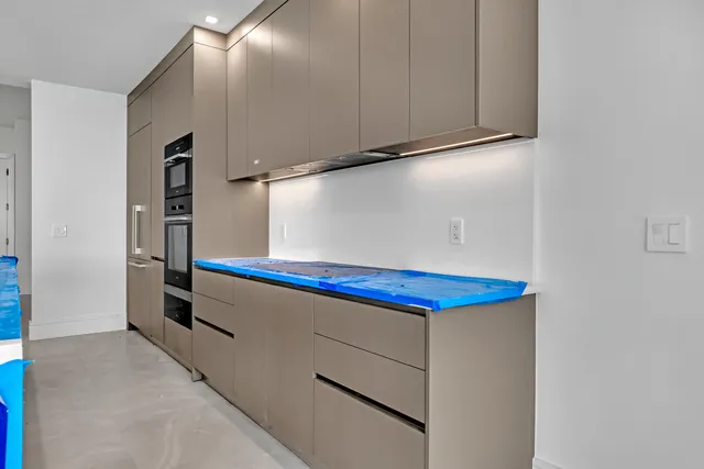 an aerial view of a house with a swimming pool and a garden