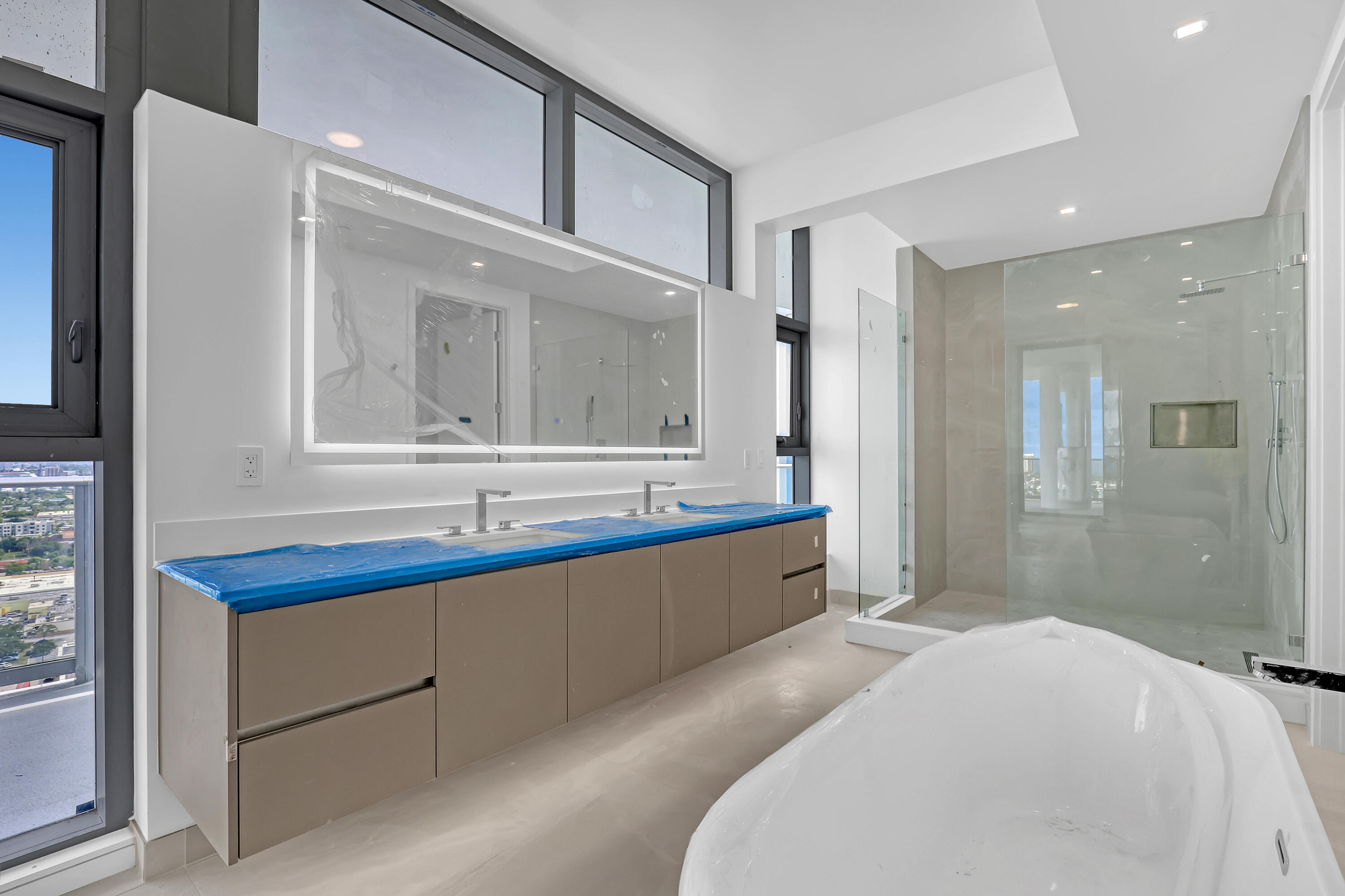 220 Lake Shore Drive, Unit N2103 Lake Park, FL 33403 - Photo 53 of 57 a bathroom with a sink mirror and a bathtub