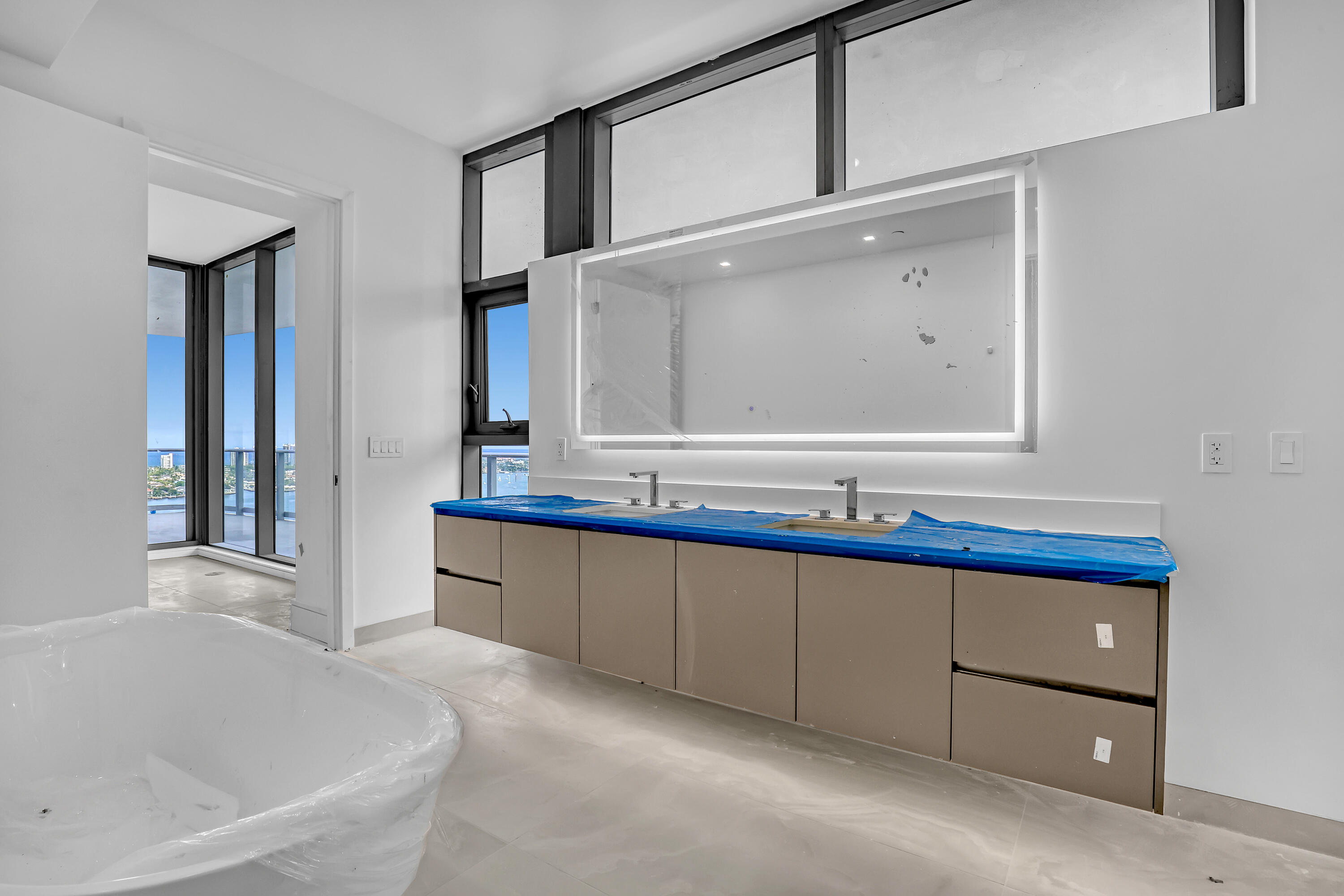 220 Lake Shore Drive, Unit N2103 Lake Park, FL 33403 - Photo 57 of 57 a bathroom with a tub sink and mirror