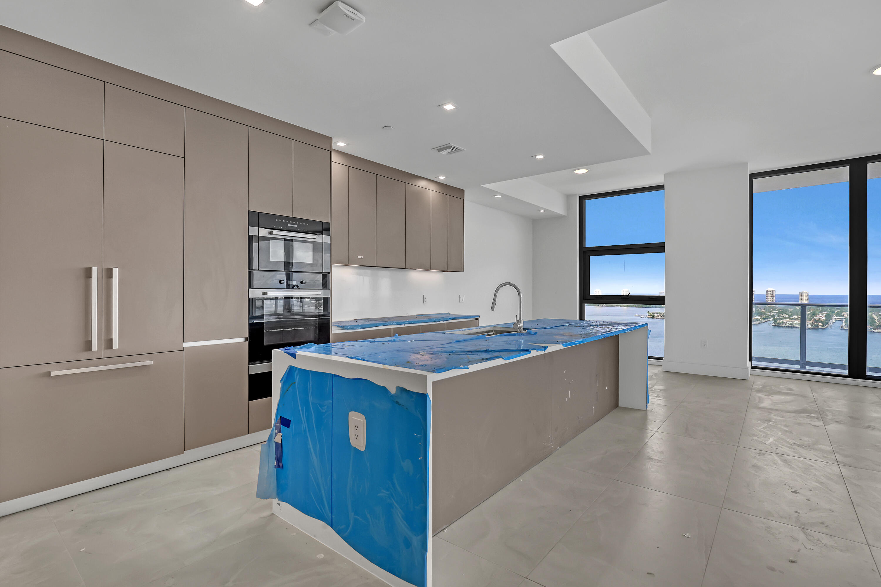 220 Lake Shore Drive, Unit N2103 Lake Park, FL 33403 - Photo 9 of 57 a kitchen with stainless steel appliances granite countertop a refrigerator a sink and a stove