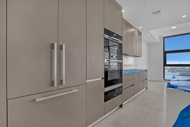 a view of an empty room with windows and city view