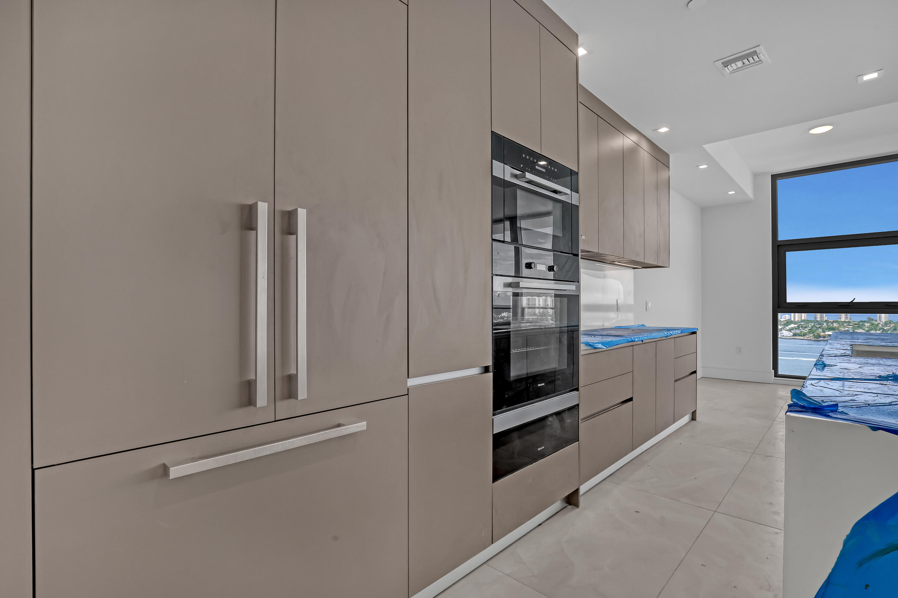 220 Lake Shore Drive, Unit N2103 Lake Park, FL 33403 - Photo 10 of 57 a kitchen with stainless steel appliances a refrigerator and a stove top oven