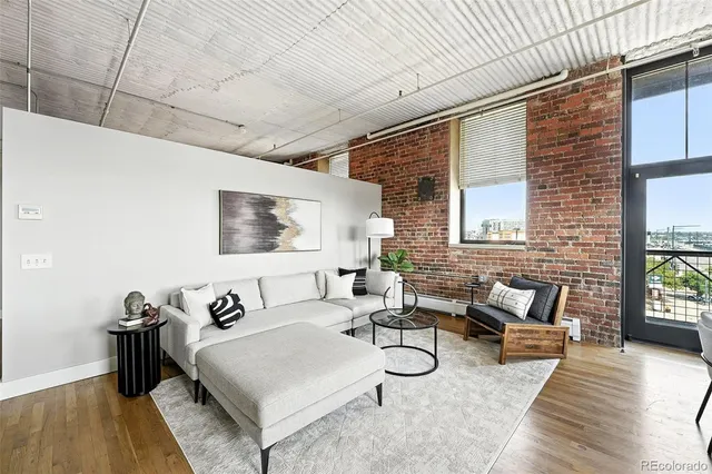 a kitchen with stainless steel appliances granite countertop a sink a counter space a refrigerator and cabinets