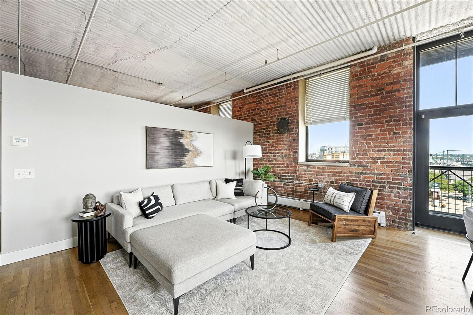 2261 Blake Street, Unit 3E Denver, CO 80205 - Photo 11 of 46 a living room with furniture and a wooden floor