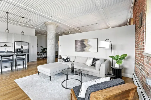 a kitchen with a dining table chairs stainless steel appliances and cabinets
