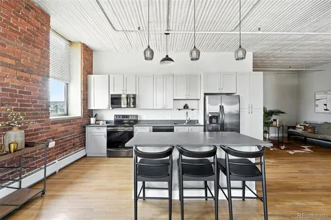 a living room with fireplace furniture and a wooden floor