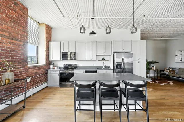 a living room with furniture a table and wooden floor