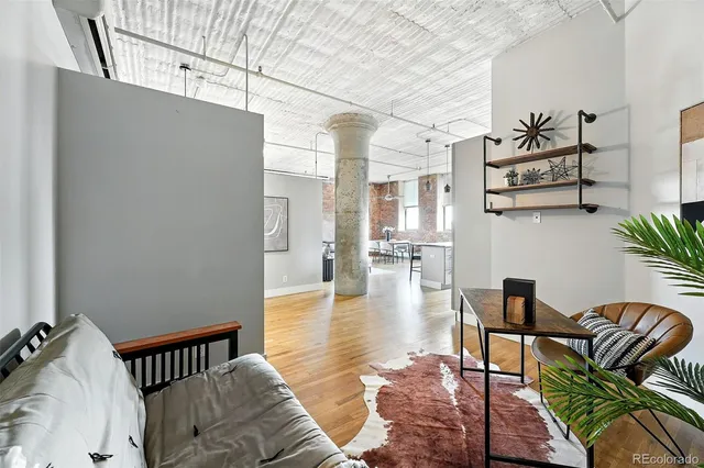 a bedroom with a bed and a potted plant