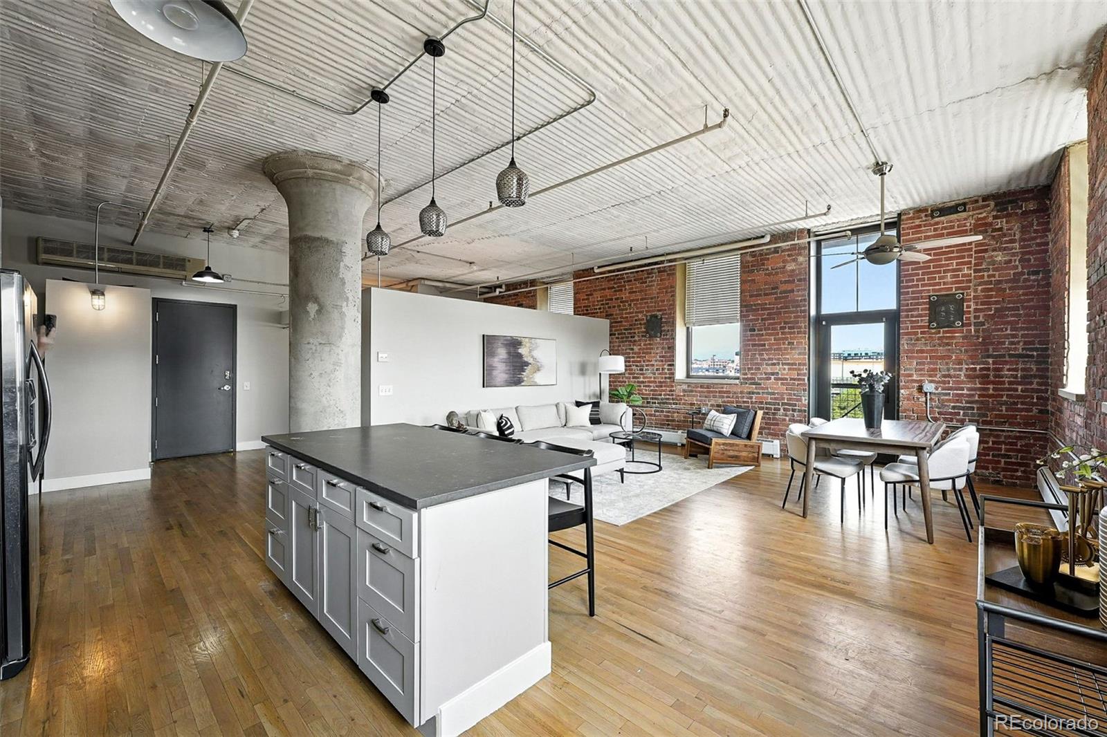 2261 Blake Street, Unit 3E Denver, CO 80205 - Photo 25 of 46 a open kitchen with cabinets stove and wooden floor