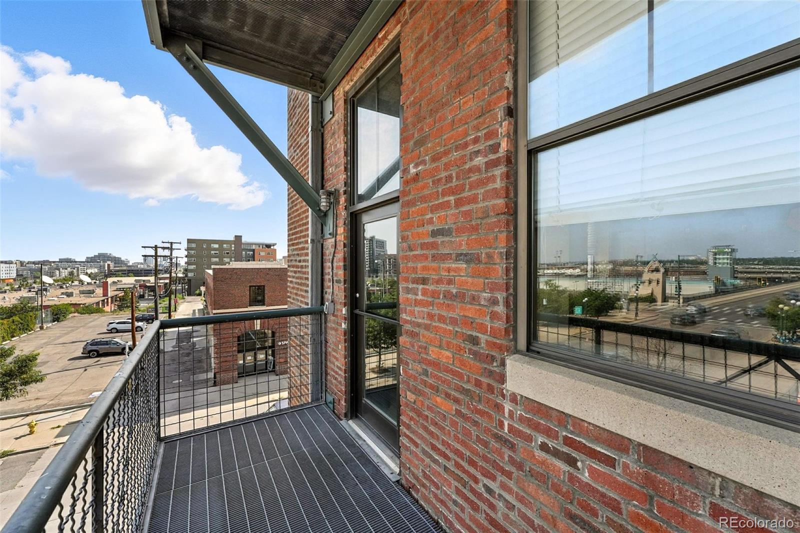 2261 Blake Street, Unit 3E Denver, CO 80205 - Photo 33 of 46 a view of a balcony with wooden floor and city view