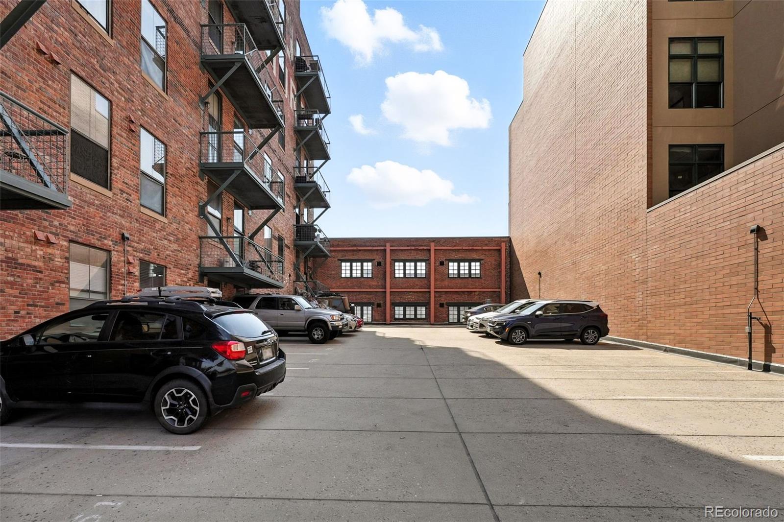 2261 Blake Street, Unit 3E Denver, CO 80205 - Photo 36 of 46 a car parked in front of a brick building