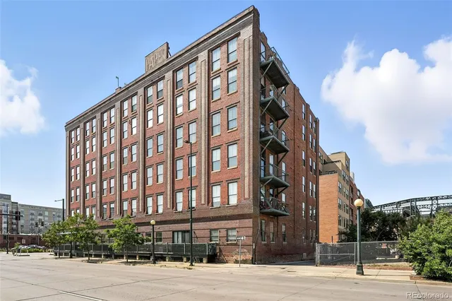 a front view of building with cars parked