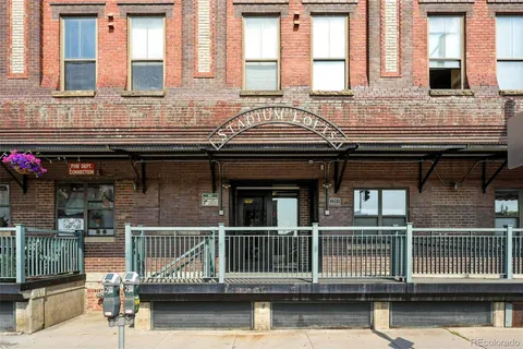 a kitchen with stainless steel appliances granite countertop a sink a refrigerator and wooden cabinets